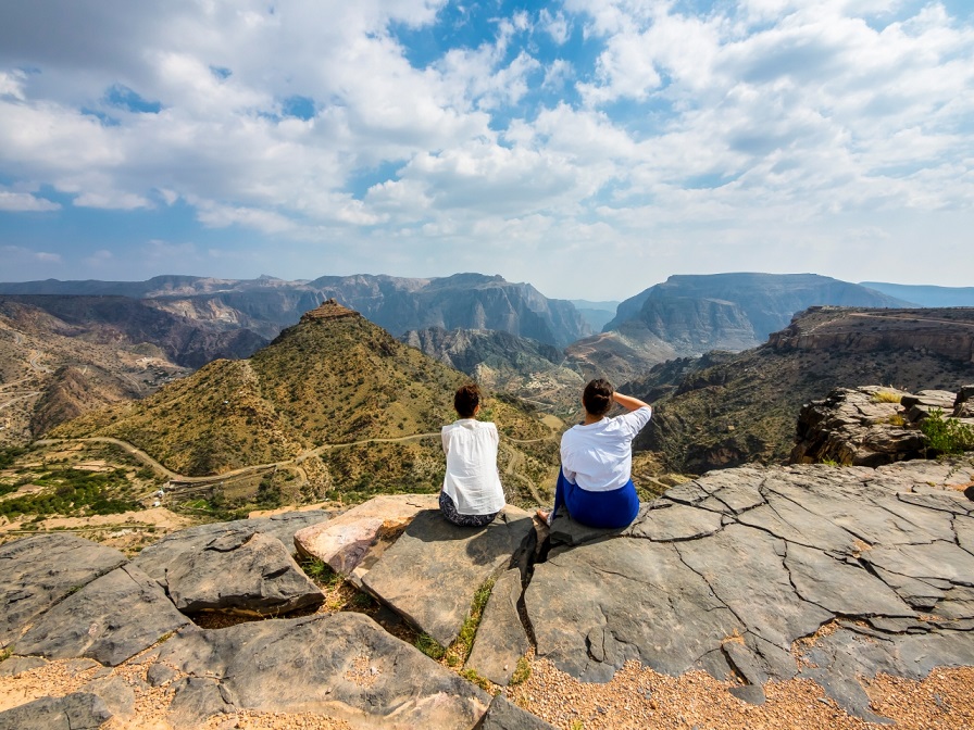 Oman, Jabal Akhdar, Two Women Looking At Mountain View